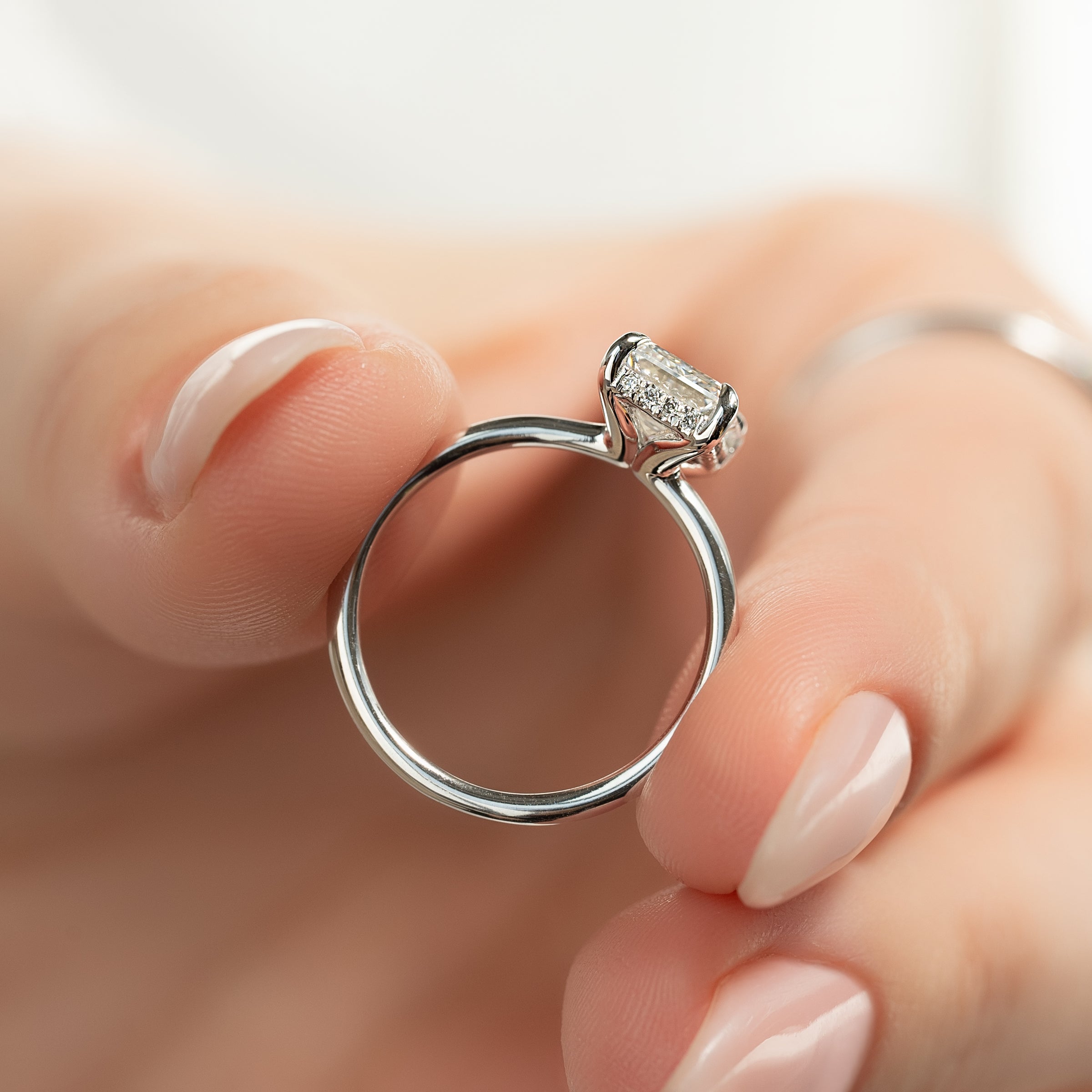 Auric Dawn Emerald 2.19 Carat VVS1 Lab-Grown Hidden Halo Engagement Ring in 18K White Gold Hand View