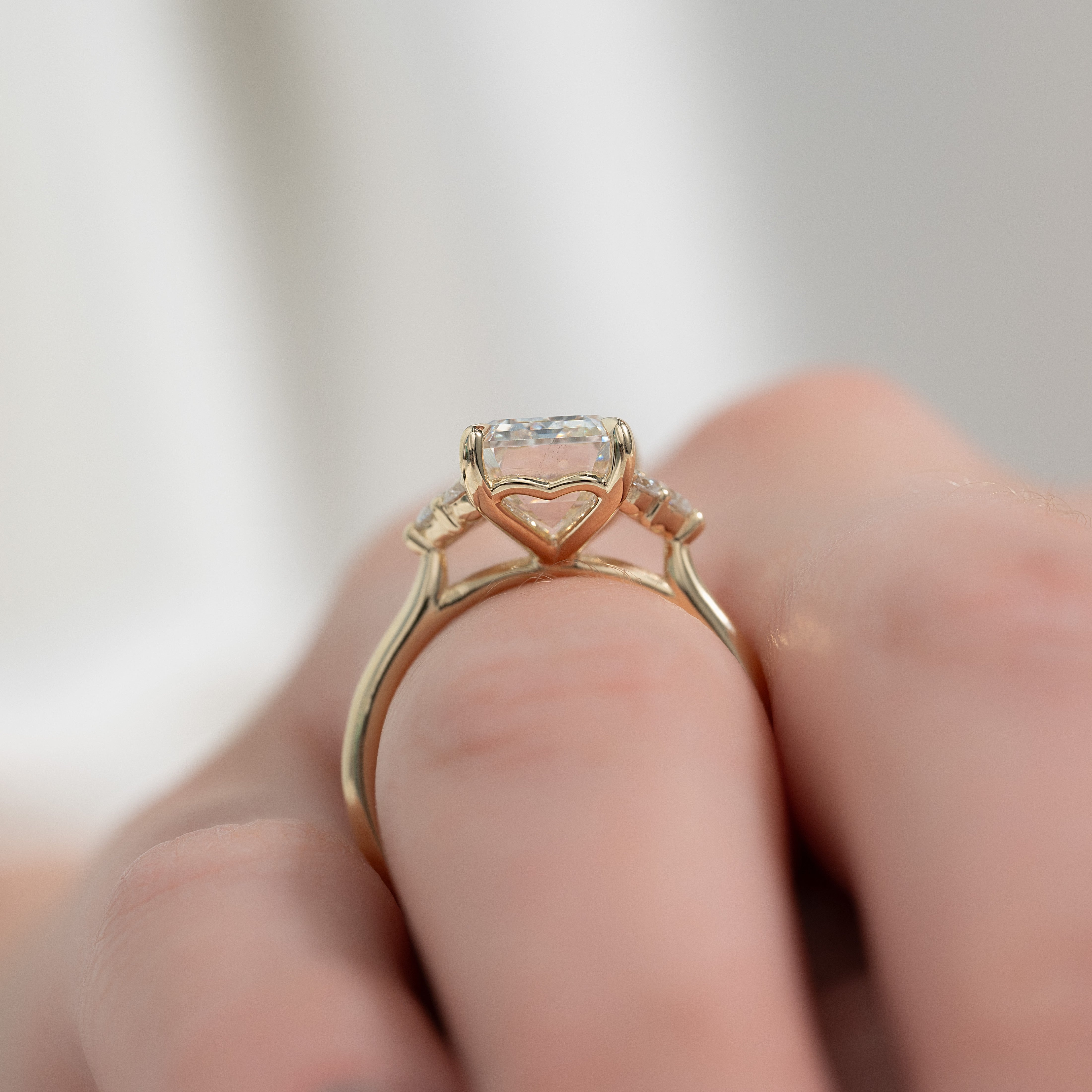 Eternal Prism 2 Carat VVS1 Lab-Grown Emerald Three Stone Engagement Ring in 18K Yellow Gold Finger Side View