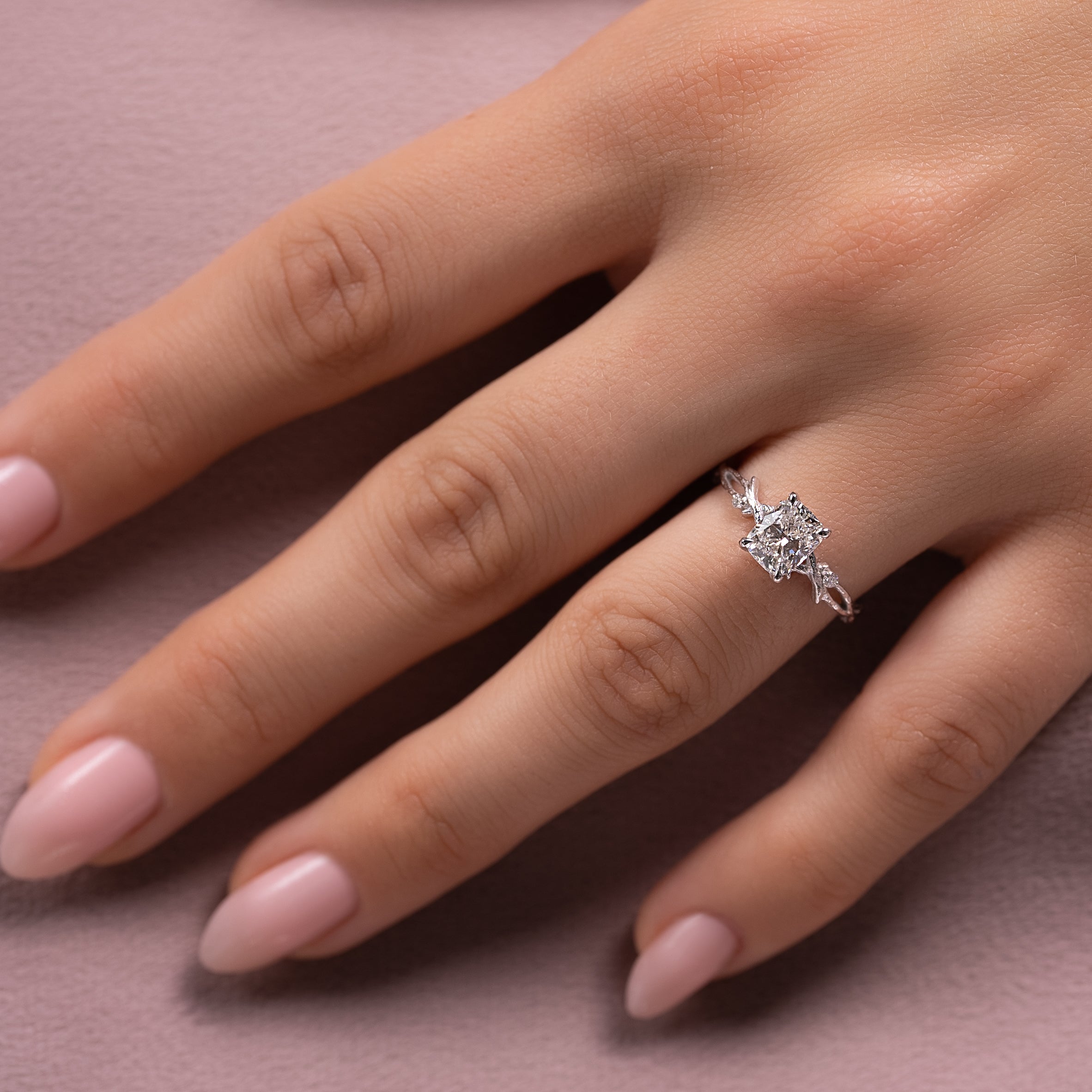 Eternal Weave 3.05 Carat VVS1 Lab-Grown Elongated Cushion Textured Three-Stone Engagement Ring in 18K White Gold Hand View