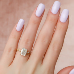 Eternal Weave 3.05 Carat VVS1 Lab-Grown Elongated Cushion Textured Three-Stone Engagement Ring in 18K Yellow Gold Hand View