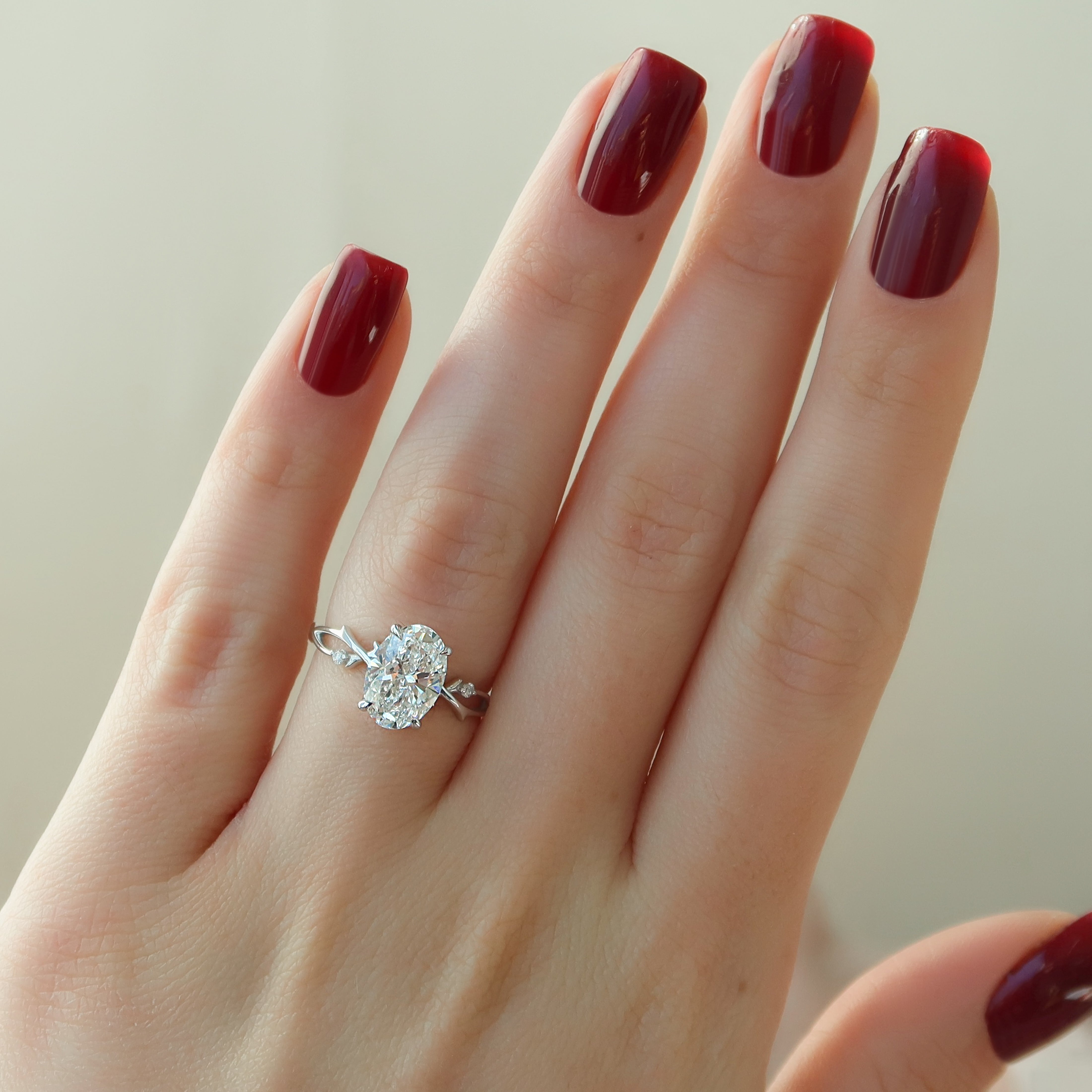 Lustrella 2.50 Carat Oval VVS1 Lab-Grown Three Stone Engagement Ring 18K White Gold Hand View