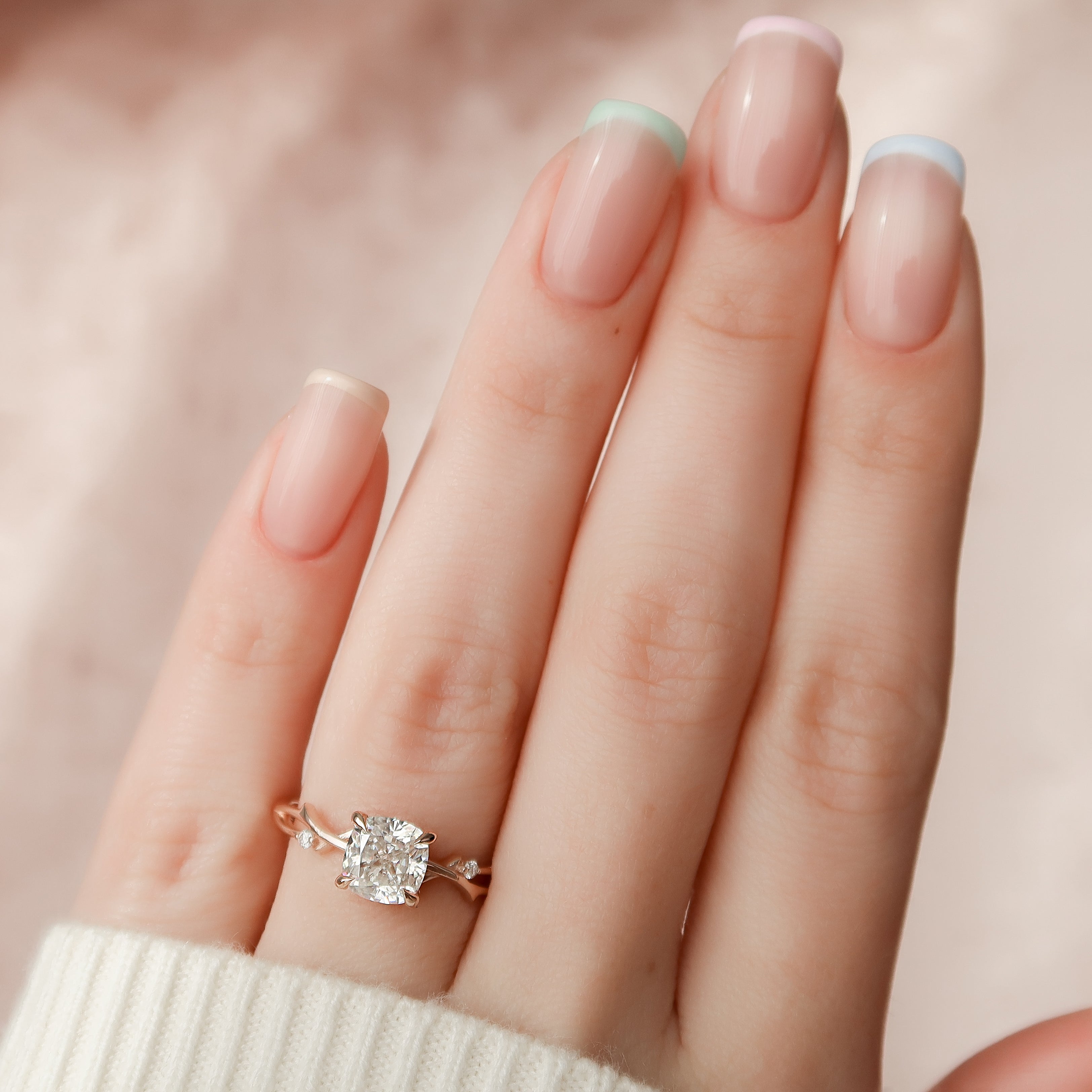 Lustrous Whim 1.50 Carat VVS1 Lab-Grown Cushion Three Stone Engagement Ring in 18K Rose Gold Finger View