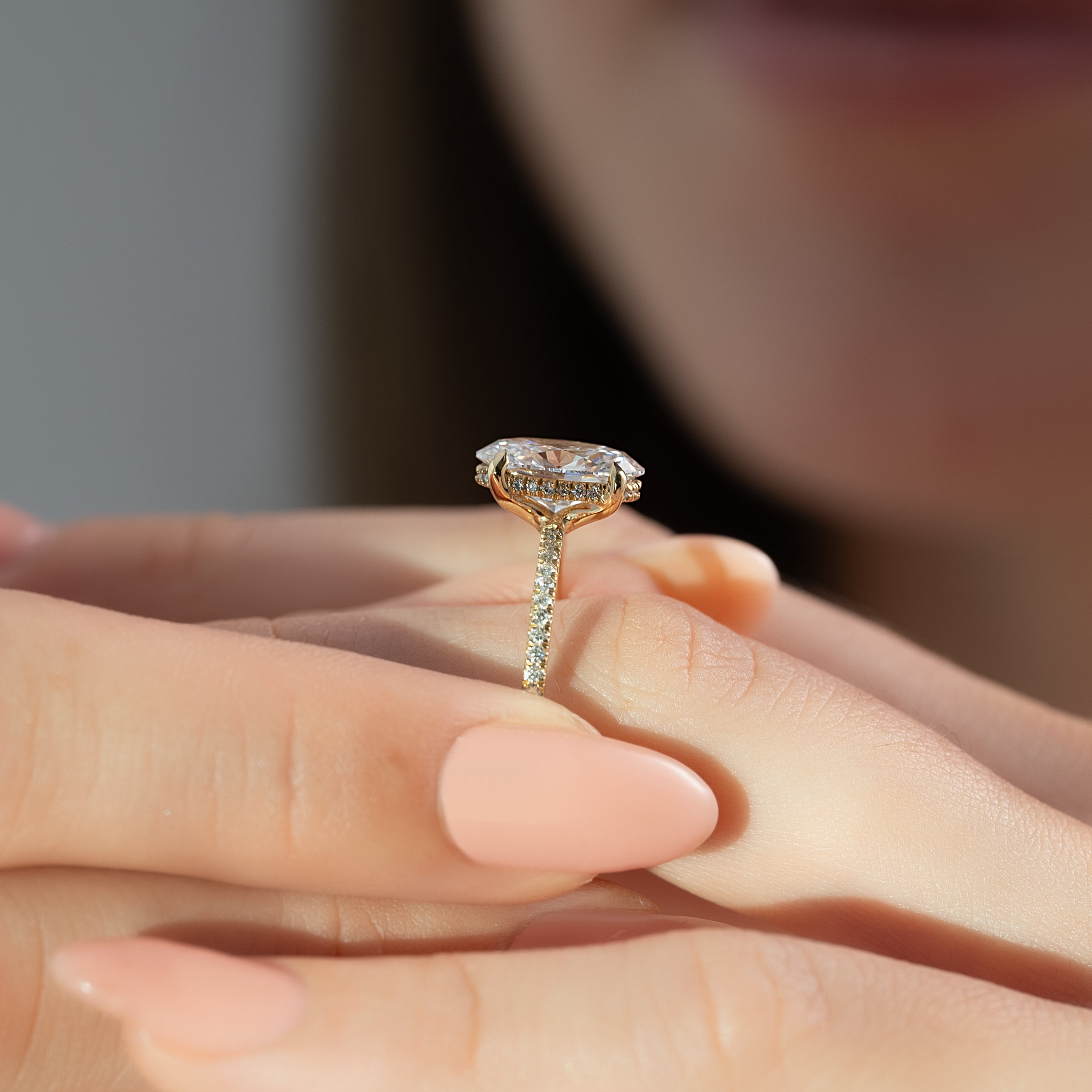 Moonlit Oval 2 Carat VVS1 Lab‑Grown Hidden Halo Pave Engagement Ring in 18K Yellow Gold Finger Closeup View