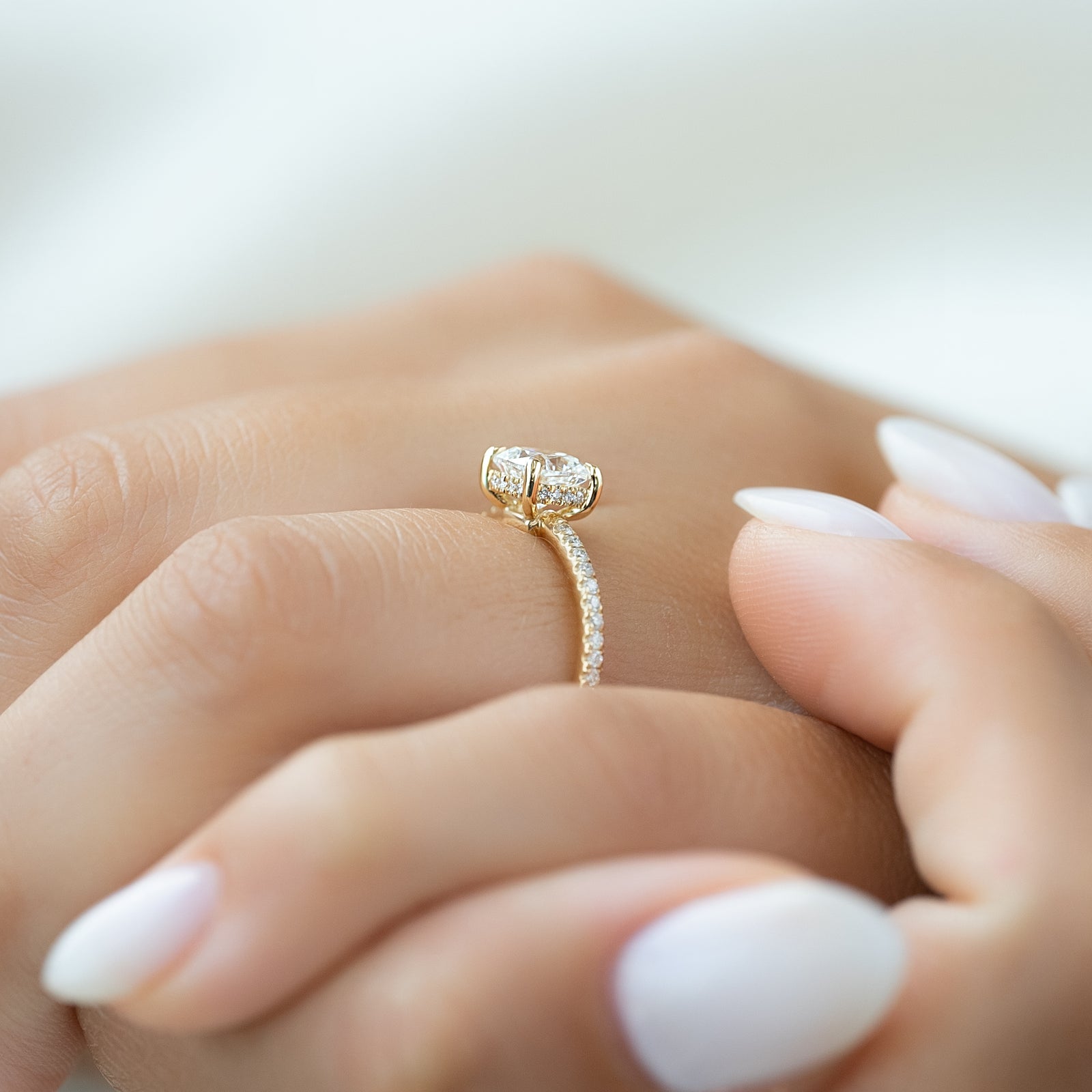 Nimbus Lyric 1 Carat VVS Lab-Grown Cushion Hidden Halo Pave Engagement Ring in 18K Yellow Gold Finger Side View 