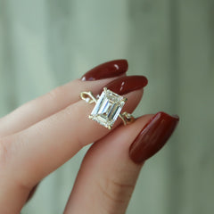 Noble Splendor 2 Carat VVS1 Lab-Grown Emerald Three Stone Engagement Ring in 18K yellow Gold Hand Closeup View