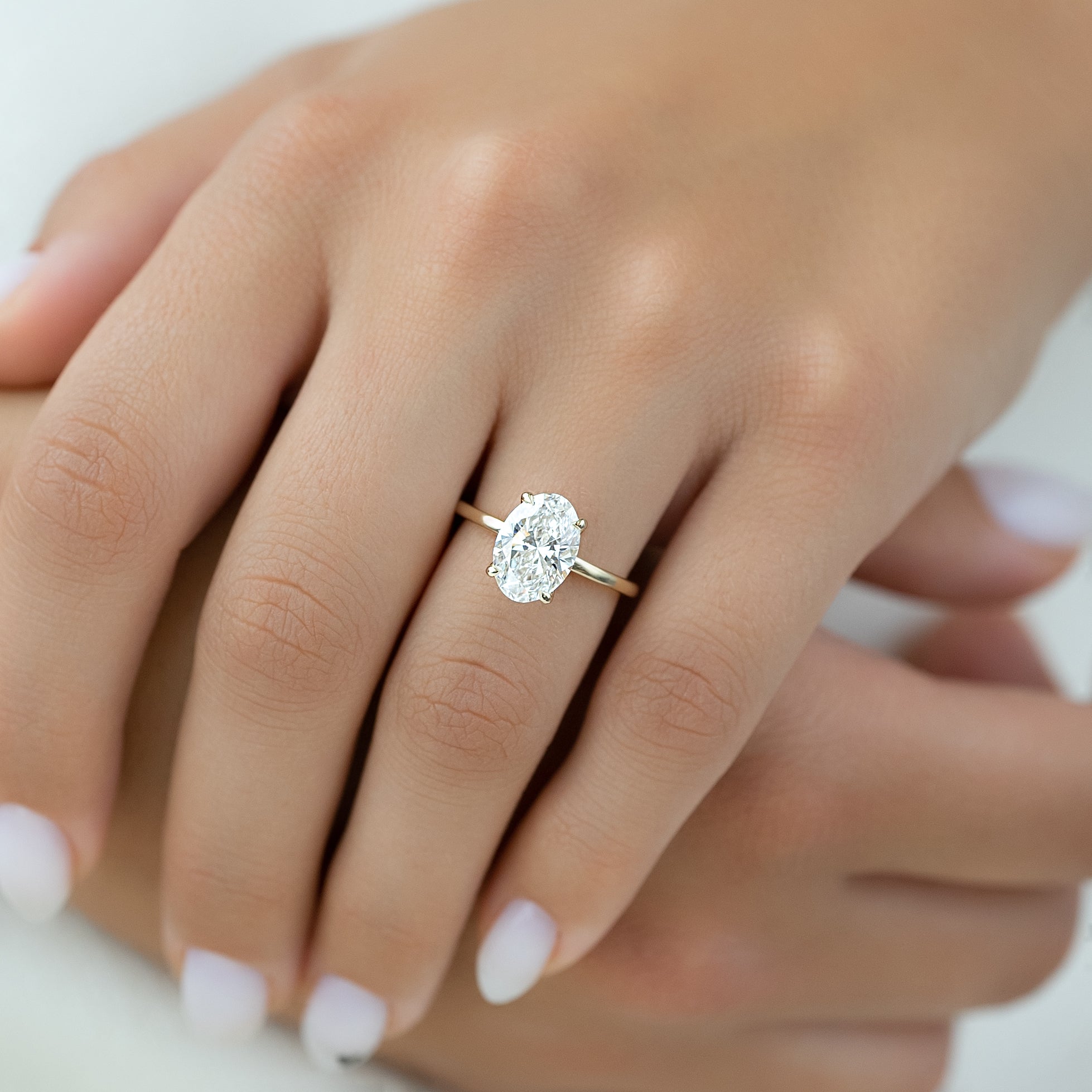 Timeless Oval 2.09 Carat VVS1 Lab-Grown Hidden Halo Engagement Ring in 18K Yellow Gold Hand View